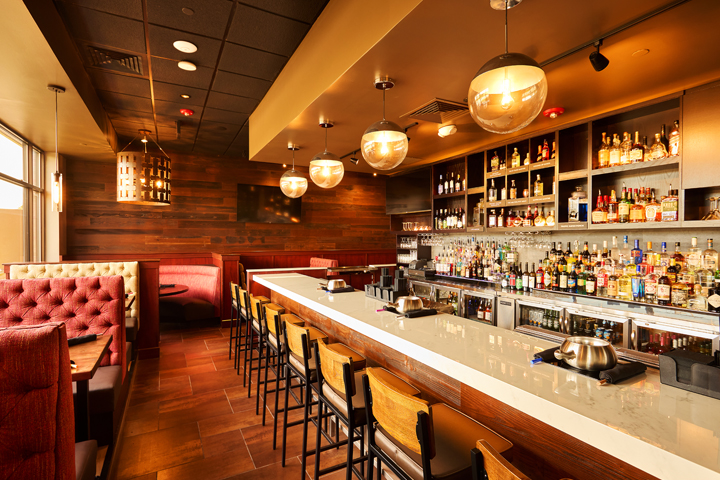 a bar with a row of bottles and lights