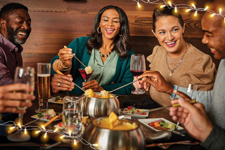a group of women eating fondue