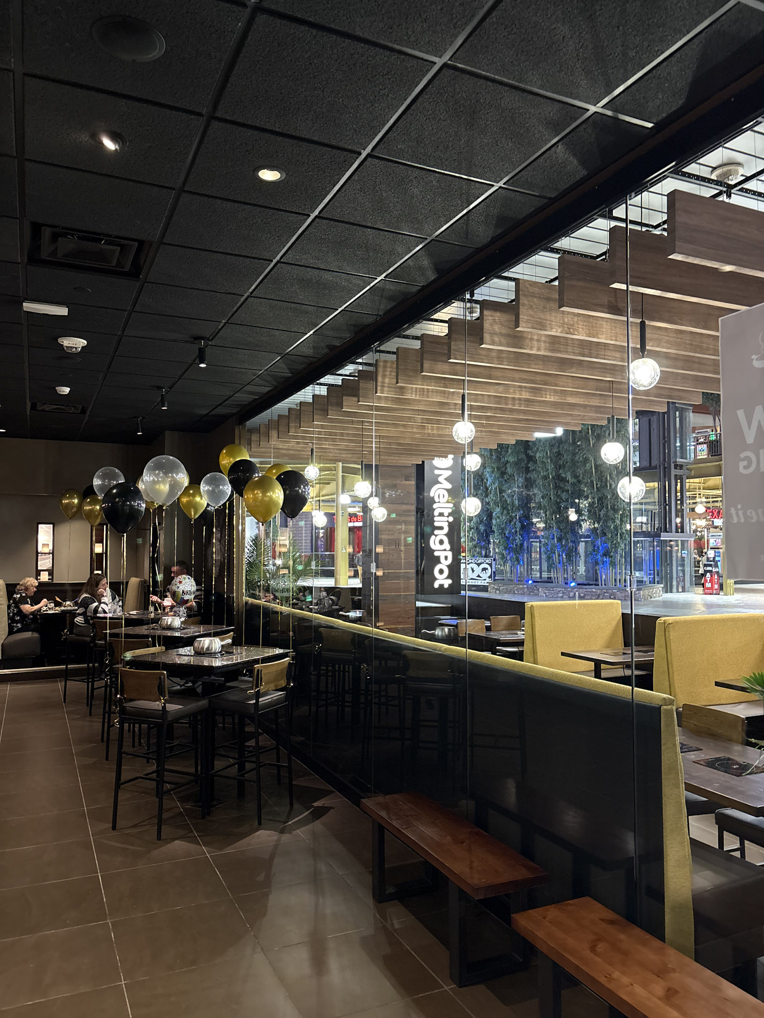 a room with tables and chairs and balloons