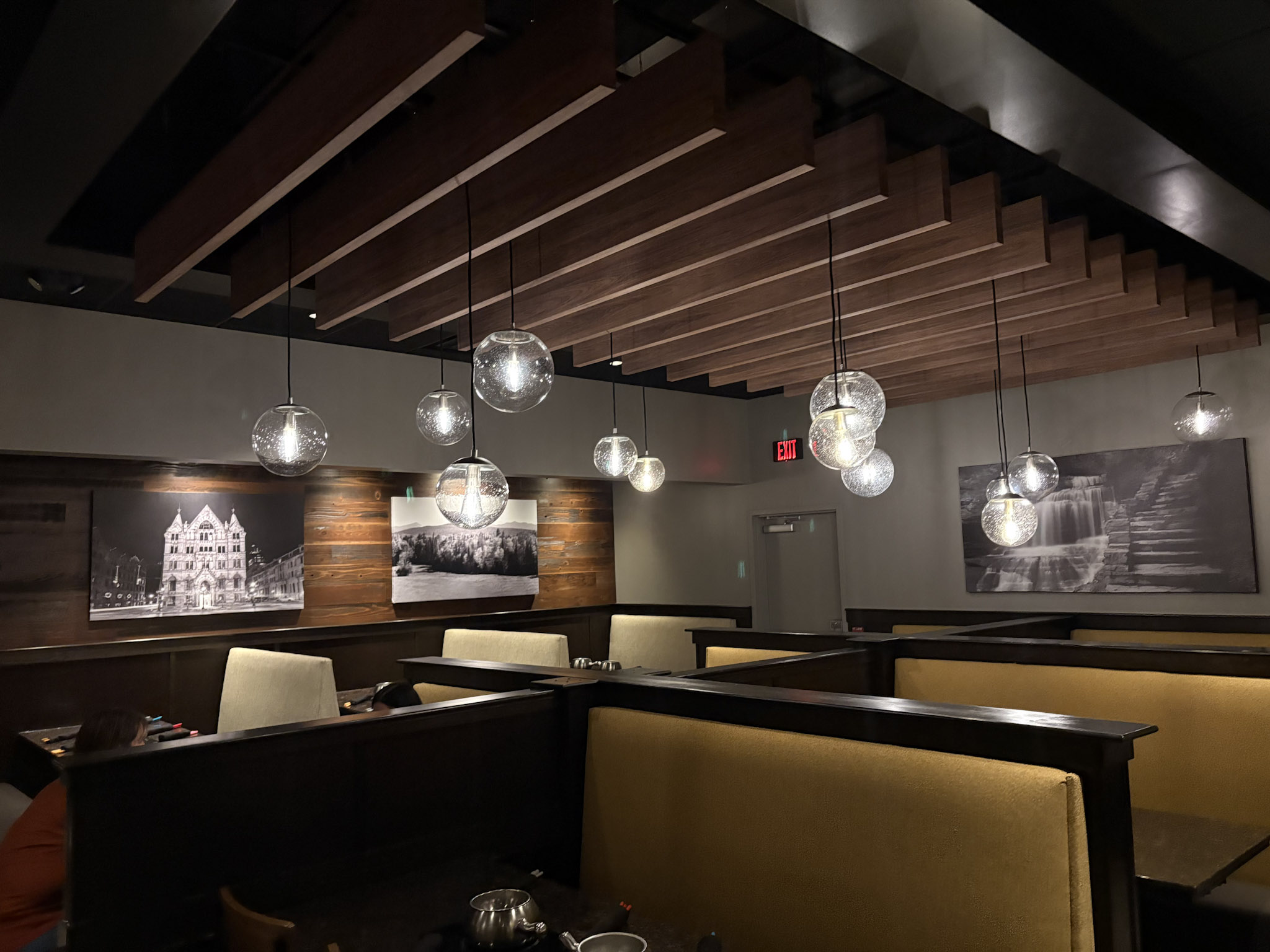a restaurant with many lights from the ceiling