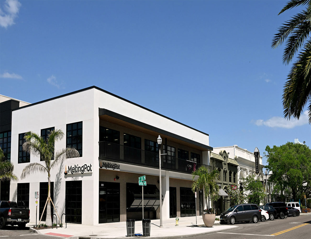 The modern, welcoming exterior of the Melting Pot restaurant in St. Petersburg, Florida, at dusk.