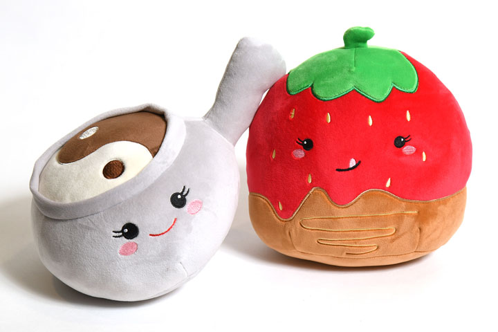 a stuffed toy with a cup and a strawberry