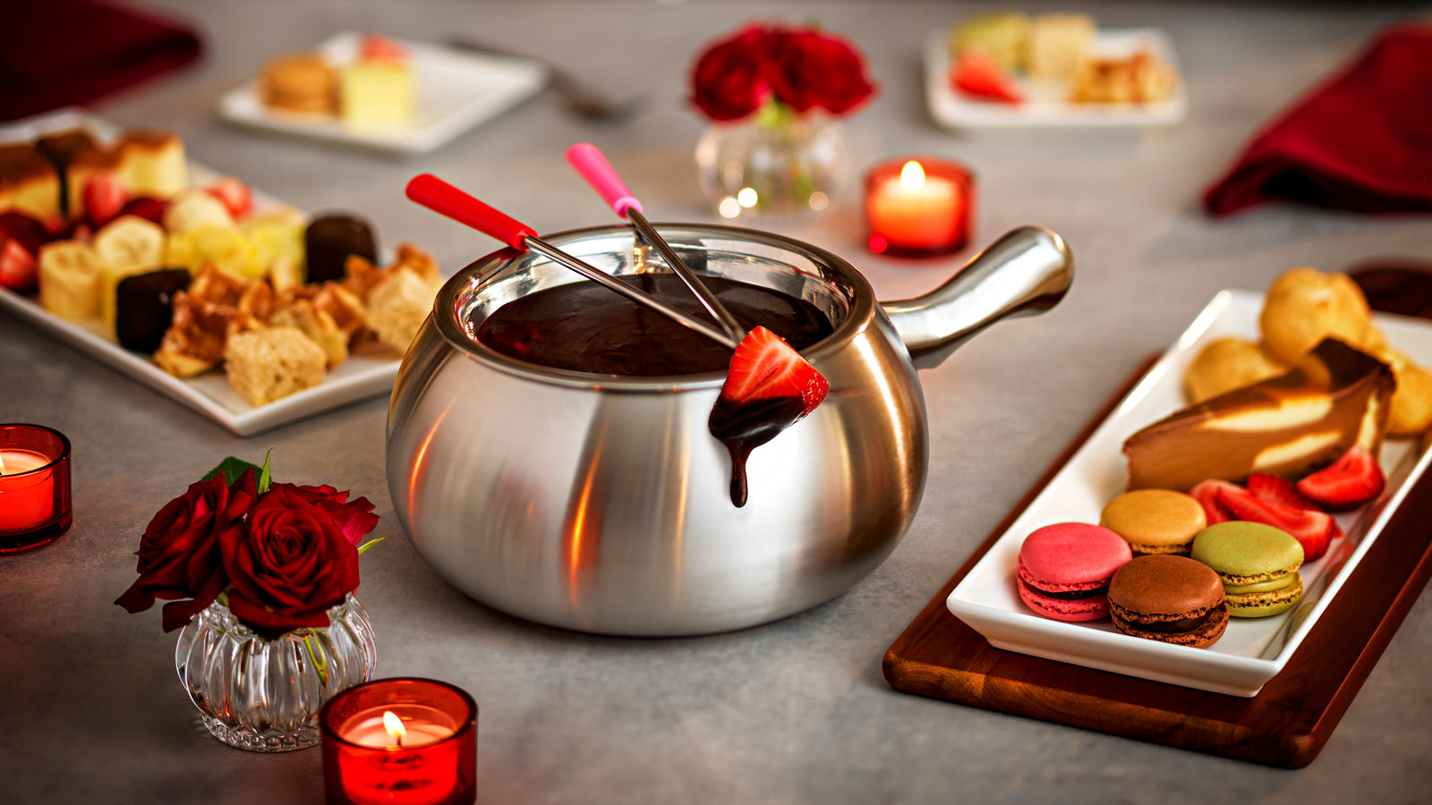a pot of chocolate fondue with a strawberry on it