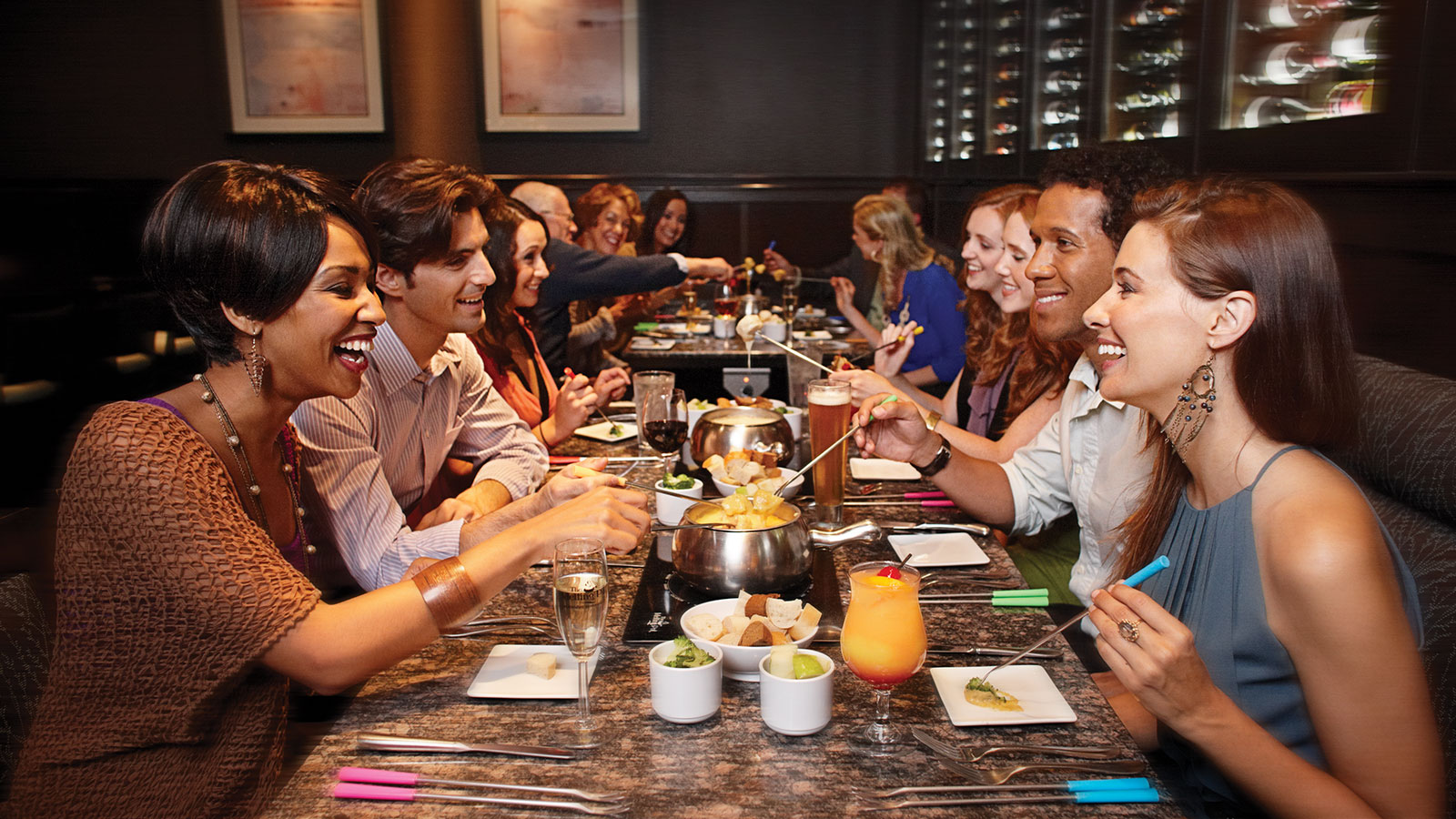 a group of people eating fondue