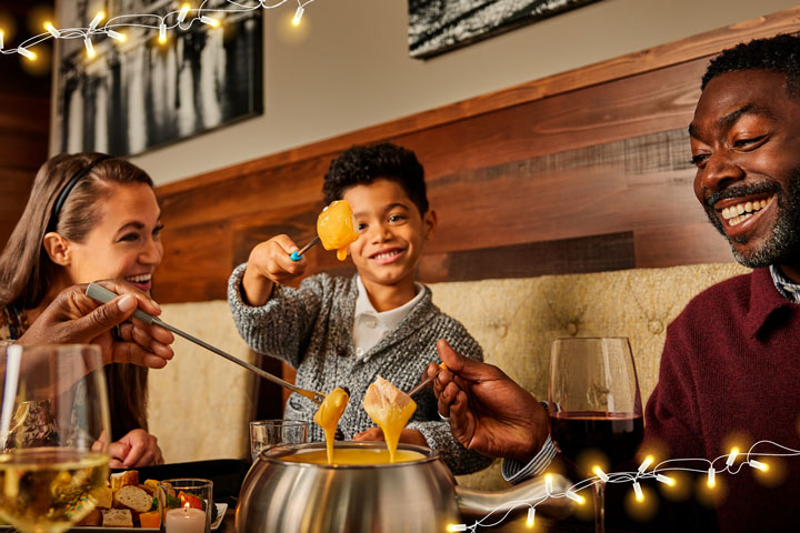 a group of people eating fondue